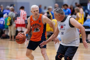 Two men playing basketball at the 2025 National Senior Games.