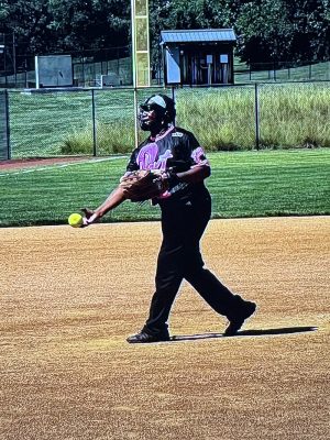 National Senior Games athlete Brenda Jones warms up on a softball field.