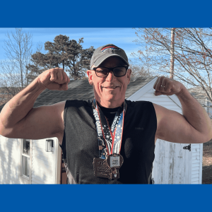 AOM-MaxCavalli-Profile Athlete Maximilian Cavalli flexes his arm muscles while smiling and wearing two medals from the National Senior Games.